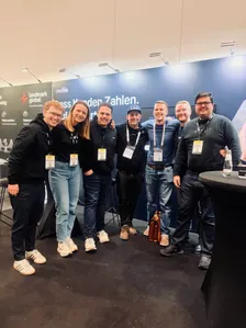 Alex Jank with fellow attendees at the Mollie booth at E-commerce Berlin Expo 2026